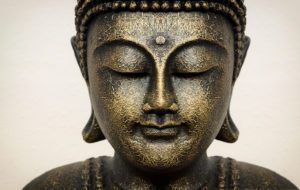 Close up of Buddha beautiful serene face with closed eyes. Best meditation inspiration image or mindfulness background.